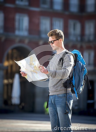 Young student backpacker tourist looking city map in holidays travel Stock Photo