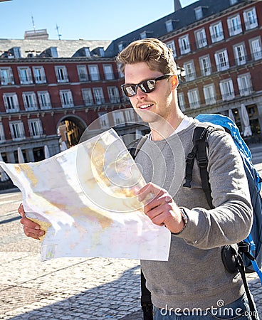 Young student backpacker tourist looking city map in holidays travel Stock Photo