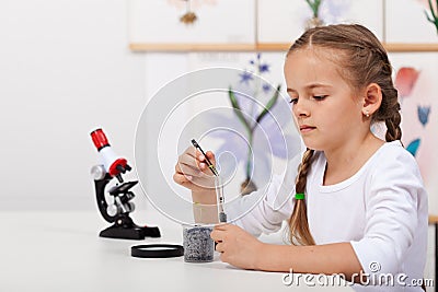 Young student in biology science class study small plants Stock Photo