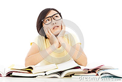 Young student girl thinking with book on the desk Stock Photo