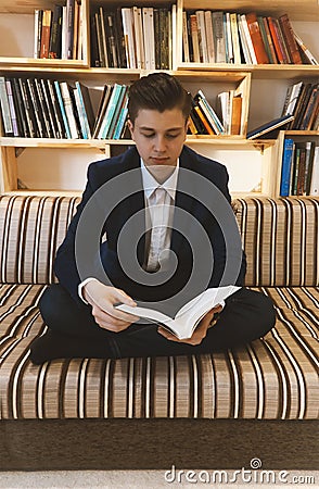 Young student learning in front of bright window Editorial Stock Photo