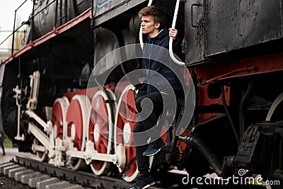 Young student man wait on Old Steam Train. future engineer technologist Stock Photo