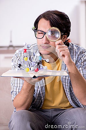 The young student physicist preparing for exam at home Stock Photo