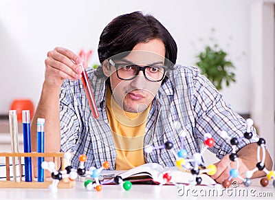 Young student physicist preparing for exam at home Stock Photo