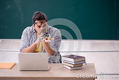 Young male student physicist sitting in the classroom Stock Photo