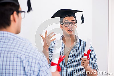 The young student planning graduation speech in front of mirror Stock Photo