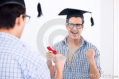 The young student planning graduation speech in front of mirror Stock Photo