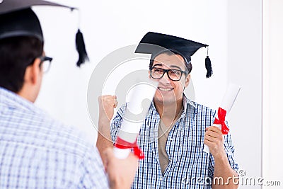 The young student planning graduation speech in front of mirror Stock Photo