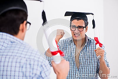 The young student planning graduation speech in front of mirror Stock Photo