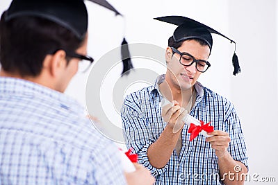 The young student planning graduation speech in front of mirror Stock Photo