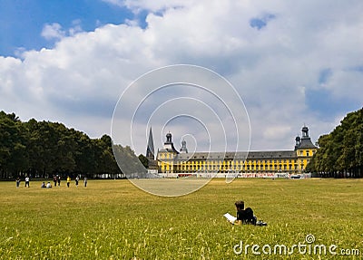 Young student resting on the grass reading a book Editorial Stock Photo