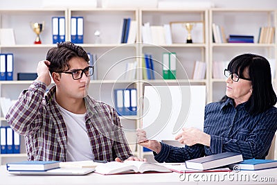 The young student and teacher during tutoring lesson Stock Photo