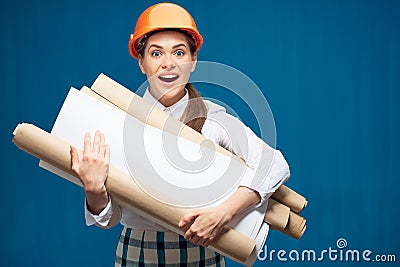 Young student woman architect holding paper plans, blueprints Stock Photo