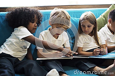 Young Students Reading Children Story Book Stock Photo