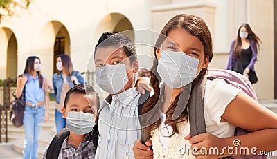 Young Students on School Campus Wearing Medical Face Masks Stock Photo