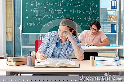 The young students taking the math exam in classroom Stock Photo