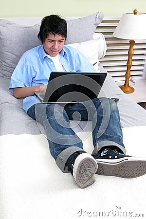 Young studying on the bed with laptop Stock Photo