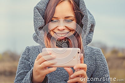Young style girl making selfie with mobile phone in a park. Stock Photo