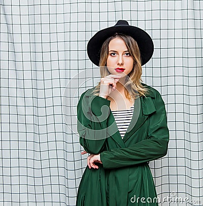 Young style woman in hat and green cloak in 90s style Stock Photo