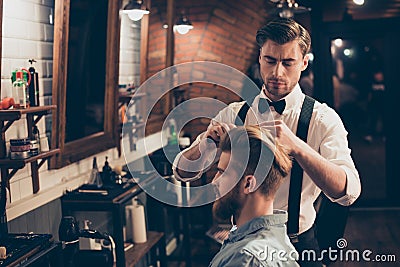 Young stylish bearded guy is in a barber shop, getting brend new Stock Photo