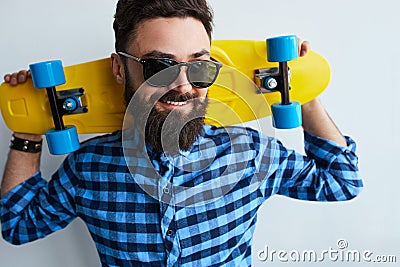Young stylish confident happy handsome man with skateboard Stock Photo