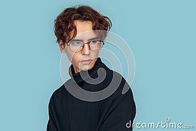 Freestyle. Man in glasses standing isolated on gray looking aside curious close-up Stock Photo