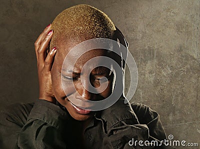 Young stylish sad and depressed afro american black woman crying in despair holding head with hands feeling miserable and desperat Stock Photo