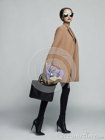 Young stylish woman in beige coat Stock Photo