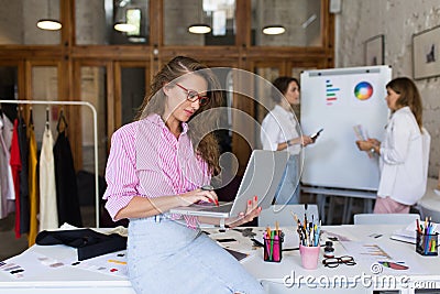 Young stylish woman in striped shirt and denim skirt and eyeglas Stock Photo