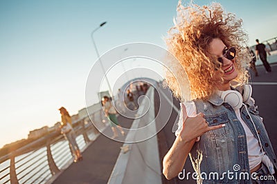 Young stylish woman with very lush hair show The Shaka Sign Stock Photo