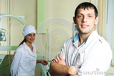 Young successful dentist with his assistant Stock Photo