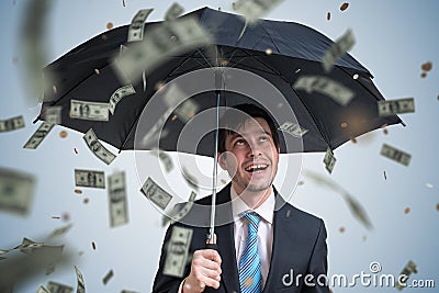 Young successful rich businessman with umbrella and money falling down. Stock Photo