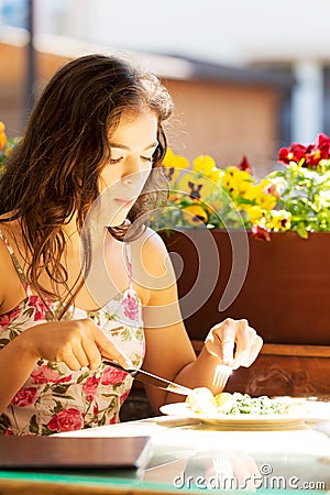 Young summer woman eating dinner. Stock Photo