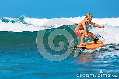 Young surfer learn to ride on surfboard on sea waves Stock Photo