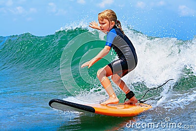 Young surfer rides on surfboard with fun on sea waves Stock Photo