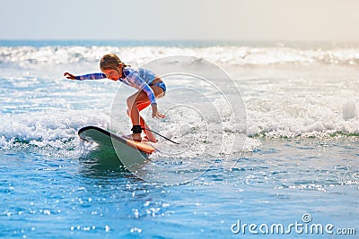 Young surfer rides on surfboard with fun on sea waves Stock Photo