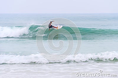 surfer riding wave motion blur Editorial Stock Photo