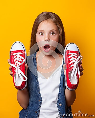 Young surprised girl with red gumshoes Stock Photo