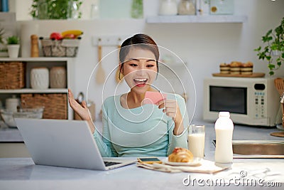 Young surprised wondered woman using laptop computer, buying with credit bank card, smiling Stock Photo