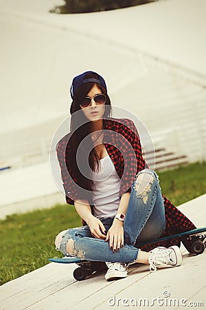 Young Swag Girl With Skateboard Posing At Street Stock Photo