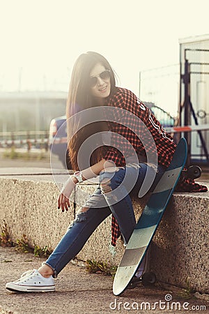 Young Swag Girl With Skateboard Posing At Street Stock Photo