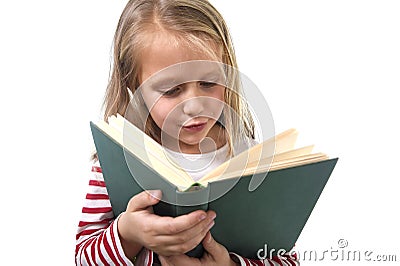 Young sweet little 6 or 7 years old with blond hair girl reading a book looking curious and fascinated Stock Photo