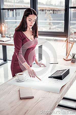 Young talented architecture working on important apartment plan in work studio Stock Photo