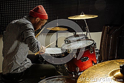 Young talented man emotionally play the drums Stock Photo