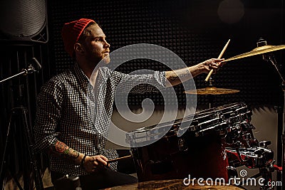 Young talented man emotionally play the drums Stock Photo