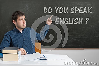 Young teacher is teaching English language at school Stock Photo