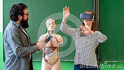 Young teacher using Virtual Reality Glasses and 3D presentation. Education, VR, Tutoring, New Technologies and Teaching Methods. Stock Photo