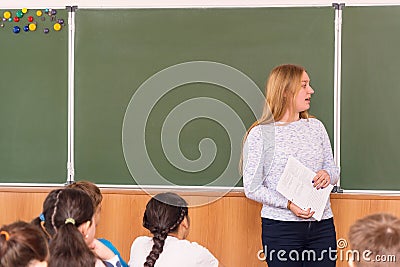 Young teacher woman in front of the class at the blackboard Editorial Stock Photo