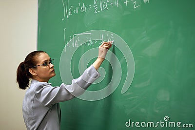 Young teacher writing on the board Stock Photo