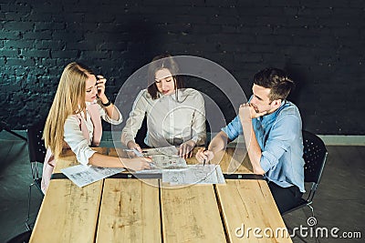 Young team of coworkers watching storyboard for shooting video in modern coworking office. Teamwork process. Horizontal Stock Photo